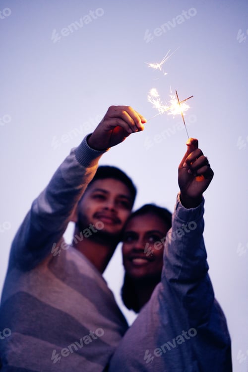 Preview: Couple, sparklers and happy together for night celebration or romance date for love, support and fr