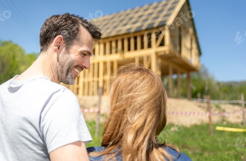 Preview: Couple looking at their new house under construction, planning future and dreaming