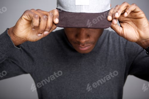 Preview: cool african american male model with hat looking down