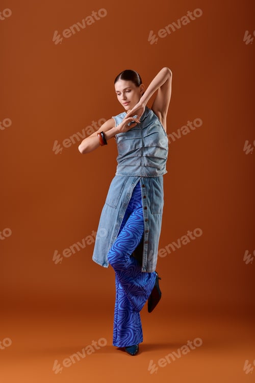 Preview: Stylish young woman showcasing unique fashion against a vibrant backdrop