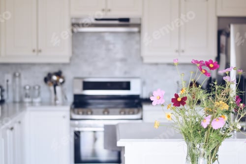Preview: A bouquet of wildflowers with a blurry modern white kitchen in the background