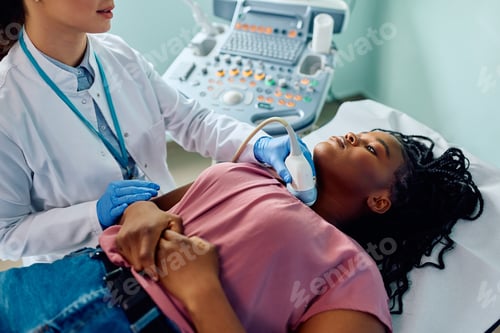 Preview: Black woman during ultrasound diagnostics of endocrine system and thyroid at medical clinic.