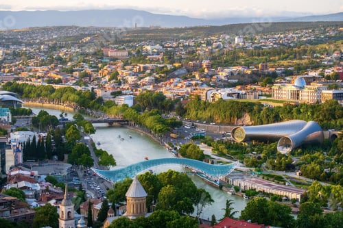 Preview: Aerial view panorama of Tbilisi with the Peace Bridge and Music hall, summer evening.