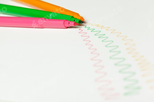 Preview: Three felt-tip pens of pink, orange and green color with drawn color marks on white background