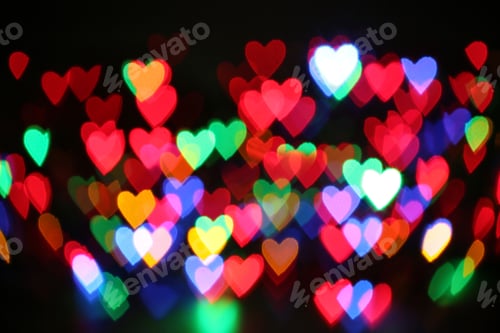 Preview: Blurred view of colorful heart shaped lights on black background