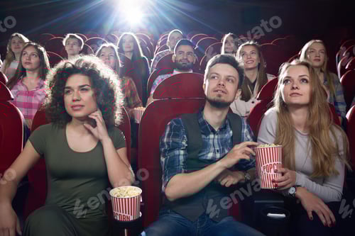 Preview: Brunette girl and couple enjoying of interesting movie