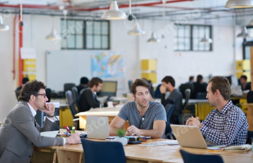 Preview: Shot of business colleagues discussing matters with the help of wireless technology in their office