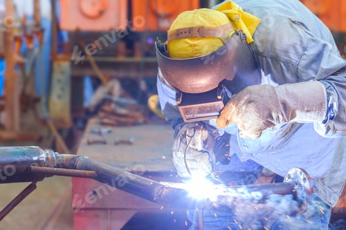 Preview: Welder with safety equipment is welding steel pipe for using in oil pipeline renovate work