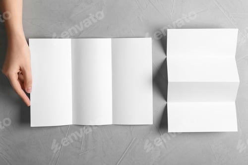 Preview: Woman with blank brochures on grey background, top view. Mockup for design