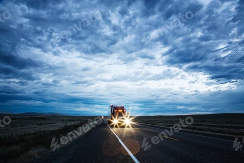 Preview: 3/4 front view of a commercial truck on the road in the early evening in eastern Washington, USA.