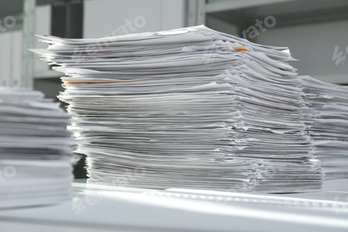 Preview: Stacks of documents on table in office