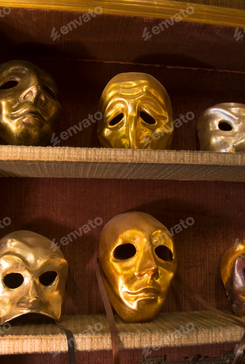 Preview: Close up of selection of golden carnival masks on shelves.