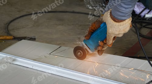 Preview: Close up of A mechanic man is using a metal cutting machine in a factory.