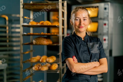 Preview: baker in a bakery against the background of ovens and a variety of fresh pastries