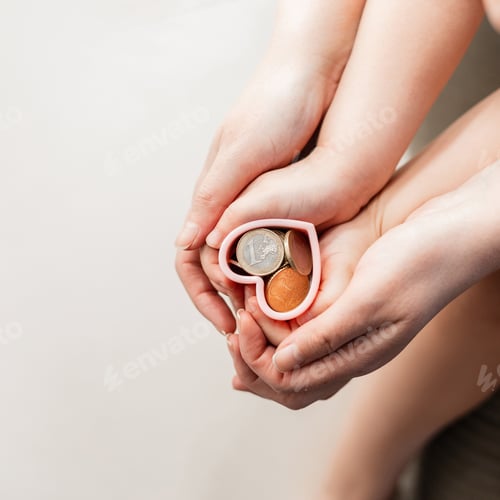 Preview: Financial literacy training from childhood concept. Mom with a child holds hands hearts with coins