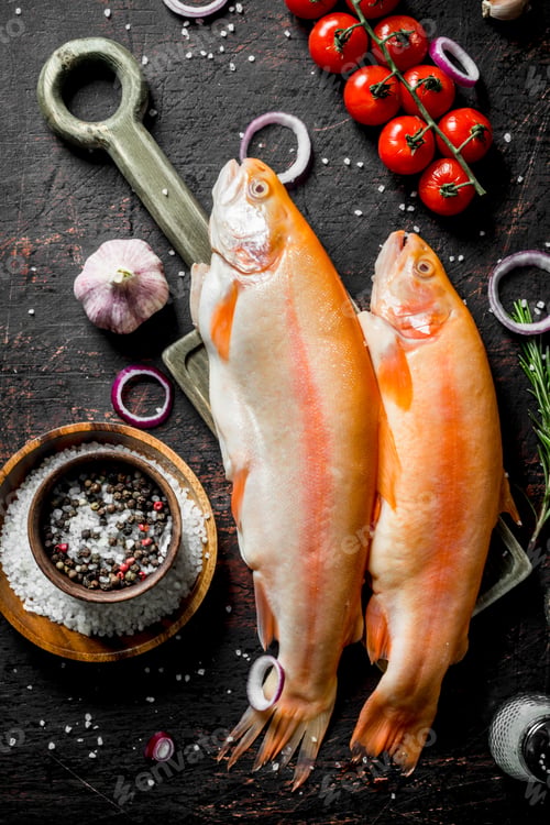 Preview: Raw fish trout with spices, tomatoes and garlic.