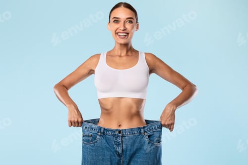 Preview: Woman Pulling Her Old Large Loose Jeans And Posing