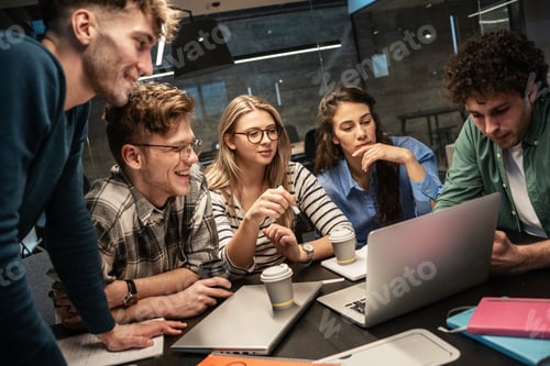 Preview: Programmers work alongside their colleagues in an office