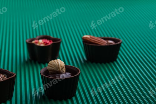 Preview: Close-up various assorted chocolate candies with nuts.