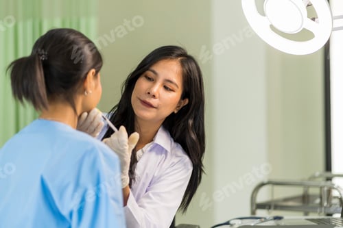 Preview: Asian woman consulting about Cosmetic surgeon and make Botox injections on face beauty procedures.