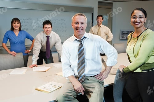 Preview: Mixed race team of business people in a conference room setting.