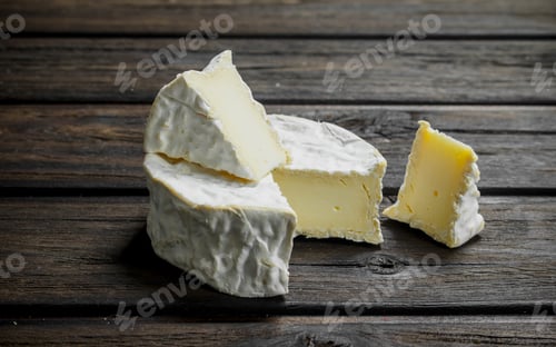 Preview: Brie cheese on wooden background.