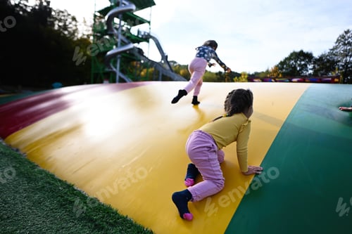 Preview: Two little girls having fun on a trampoline in the park.