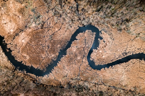 Preview: Small river and brown swamps, aerial view