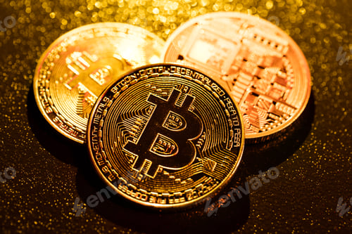 Preview: Three golden bitcoin coins on black background.