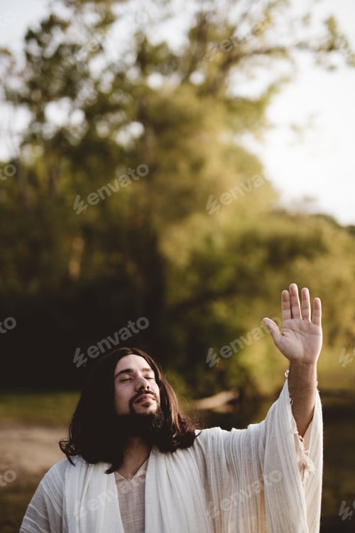 Preview: Jesus Christ whit his hand up towards the sky while his eyes are closed