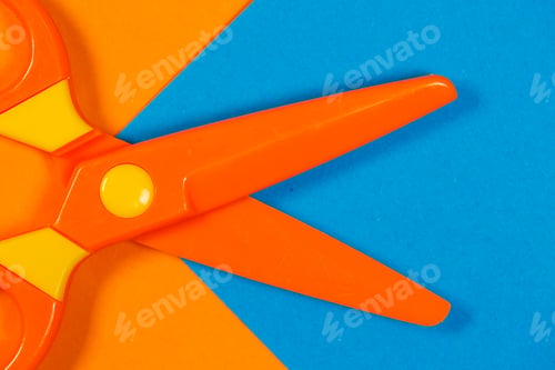 Preview: Children's plastic scissors for cutting paper figures on a colored background