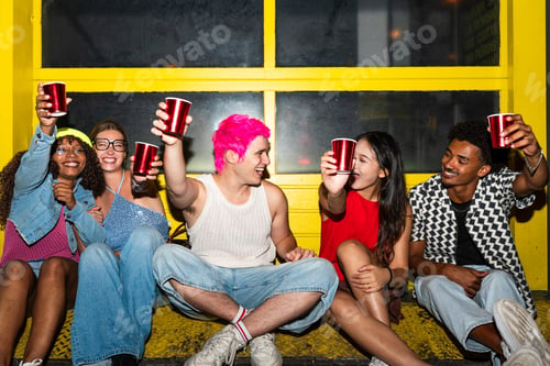 Preview: Multiethnic group of young friends having fun on the stretts in the night