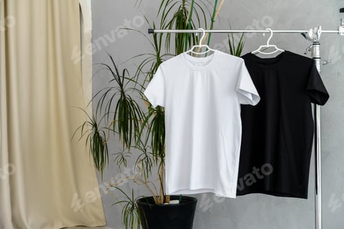 Preview: White and black T-shirts on hangers for design presentation