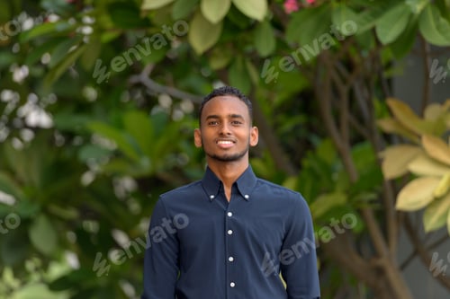 Preview: Handsome African businessman outdoors at rooftop garden smiling