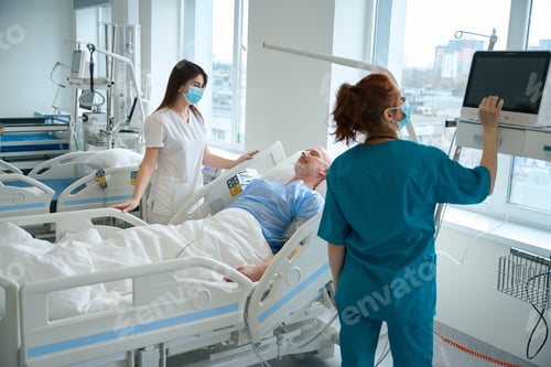 Preview: Medics evaluating state of patient's health in the reanimation room at clinic