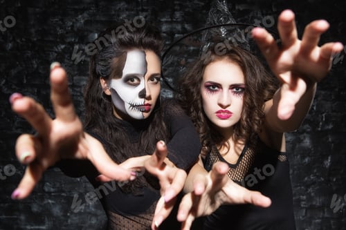 Preview: Zombie girls stretching hands toward camera, looking spooky.