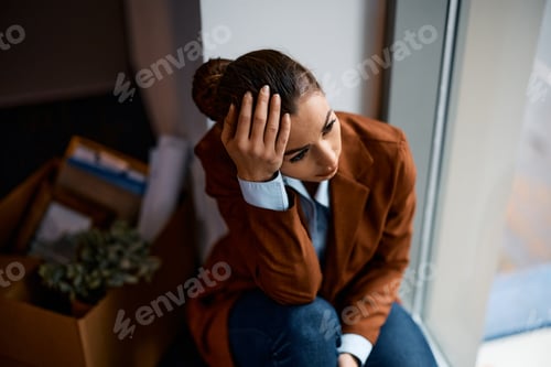 Preview: Depressed businesswoman thinking after being fired at work.