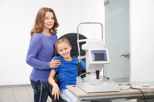 Preview: Mother and child posing in modern ophthalmology clinic