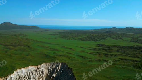 Preview: Aerial view of summer green valley and stony cleft. Clip. Flying above stunning summer hilly region.