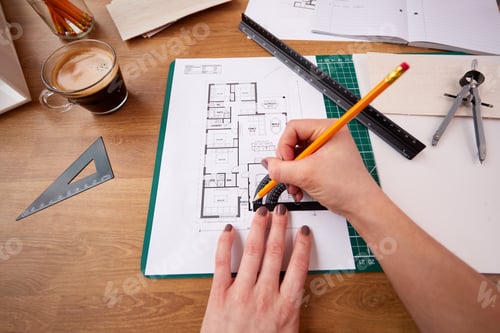 Preview: POV Shot Of Female Architect Working In Office Measuring Plans For New Building