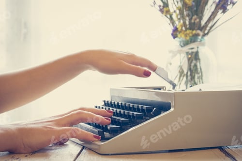Preview: Girls hands typing in vintage typewriter