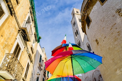 Preview: Funny colored umbrella with sky background in a city.
