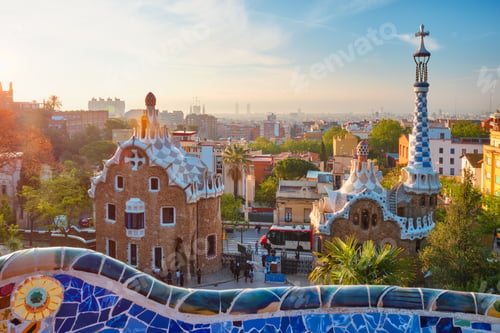 Preview: Barcelona city view from Guell Park. Sunrise view of colorful mosaic building in Park Guell