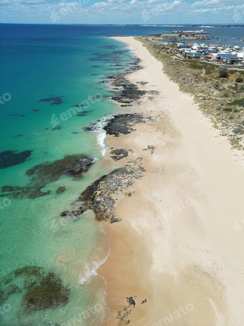 Preview: Picturesque coastal beach with crystal clear water stretching across its sandy shoreline