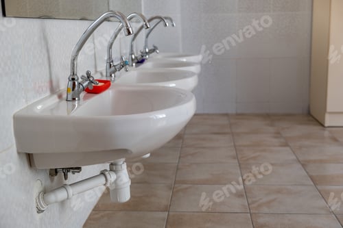Preview: White ceramic washing basins with shiny stainless steel water tap