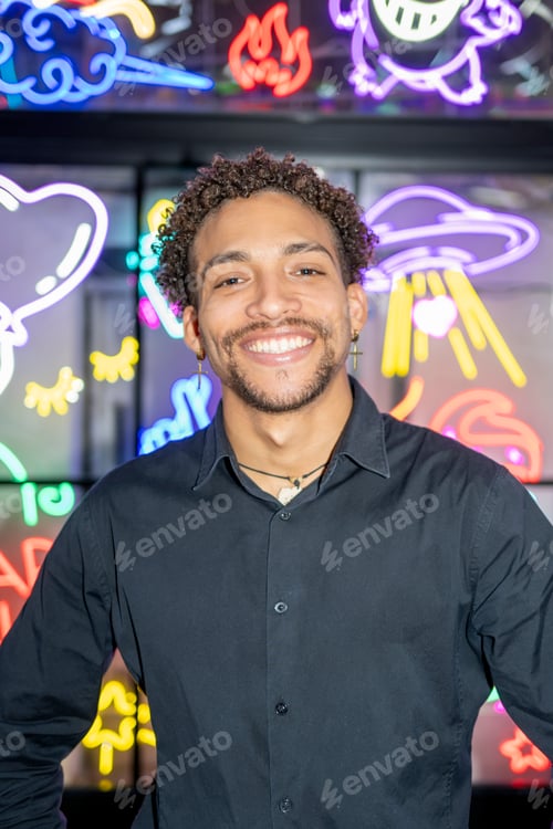 Preview: Man smiling in front of neon lights background