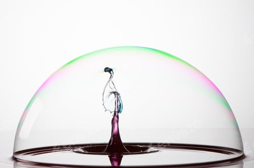 Preview: Splash of colorful liquid into a bubble with high speed flash