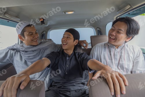 Preview: Cheerful Muslim Men Laughing And Chatting Together In Back Seat Of Car During Journey