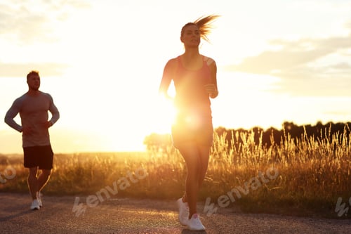 Preview: Young couple jogging in the suberbs after sunset