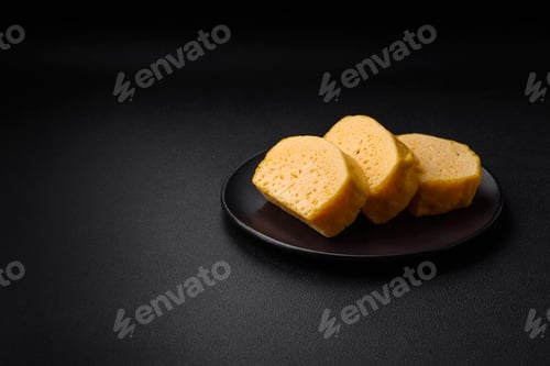 Preview: Delicious porous yellow cheese cut in large pieces on a ceramic plate